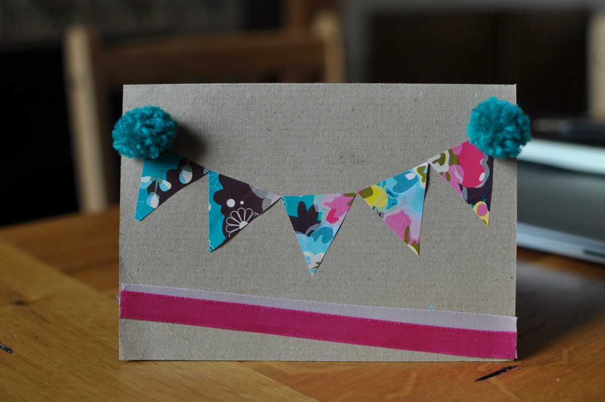 A card with floral bunting and pom poms too